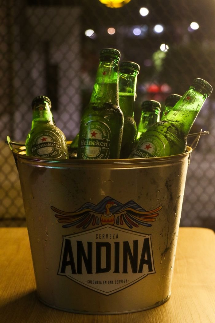 why-choose-us A collection of Heineken beer bottles chilled in an Andina bucket, perfect for parties.